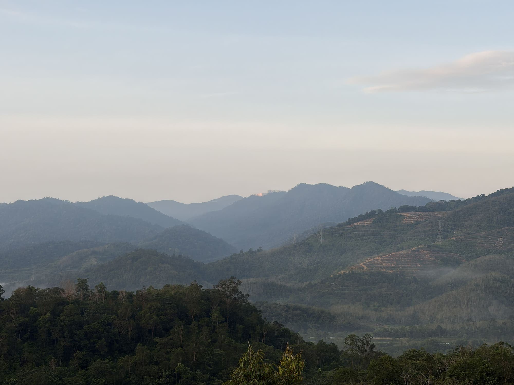 Misty mountains at dawn over the retreat valley in Pahang, Malaysia