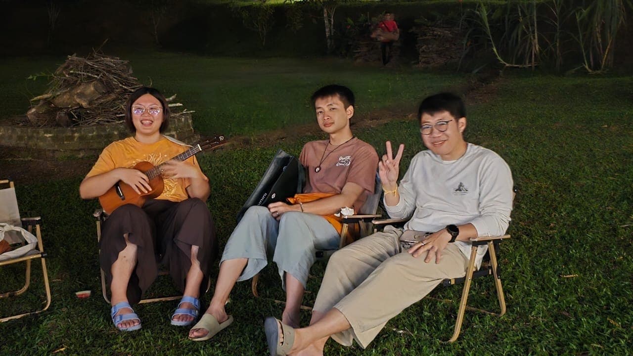 Young practitioners relaxing with music around the fire at night