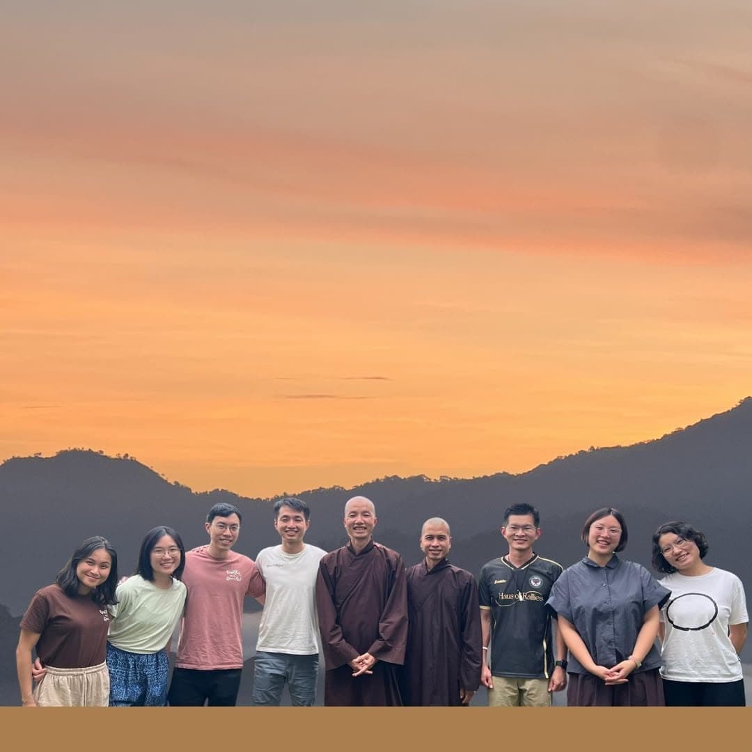 Young practitioners and monastics together at sunset in the mountains